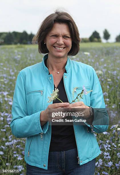 German Agriculture and Consumer Protection Minister Ilse Aigner speaks to the media while standing in a field of flowering wild chicory growing at a...