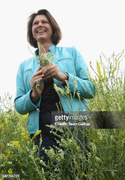German Agriculture and Consumer Protection Minister Ilse Aigner walks among flowering wild clover growing at a test field operated by the Saaten...