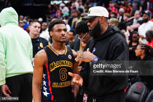 Bronny James of the West team talks to Lebron James of the Los Angeles Lakers after the 2023 McDonald's High School Boys All-American Game at Toyota...
