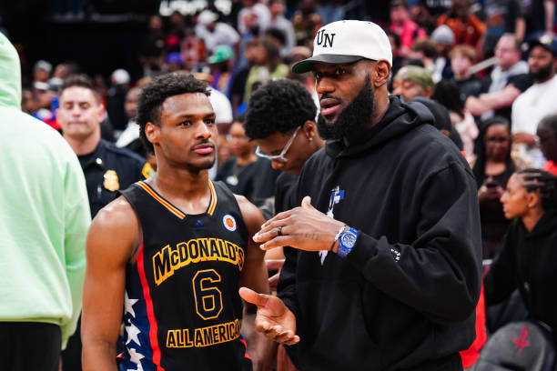 Bronny James of the West team talks to Lebron James of the Los Angeles Lakers after the 2023 McDonald's High School Boys All-American Game at Toyota...