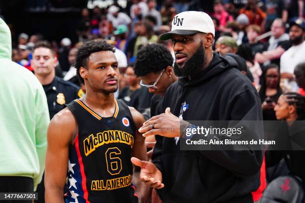 Bronny James of the West team talks to Lebron James of the Los Angeles Lakers after the 2023 McDonald's High School Boys All-American Game at Toyota...