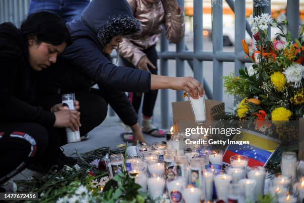 People set candles in memory of the deceased migrants after a fire at an immigration detention center in northern Mexico on March 28, 2023 in Ciudad...