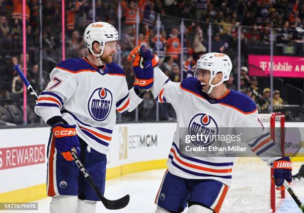 Brett Kulak and Derek Ryan of the Edmonton Oilers celebrate Kulak's third-period goal against the Vegas Golden Knights during their game at T-Mobile...