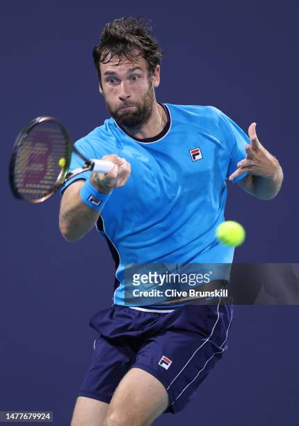 Quentin Halys of France plays a forehand against Daniil Medvedev in their fourth round match at Hard Rock Stadium on March 28, 2023 in Miami Gardens,...