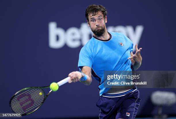 Quentin Halys of France plays a forehand against Daniil Medvedev in their fourth round match at Hard Rock Stadium on March 28, 2023 in Miami Gardens,...