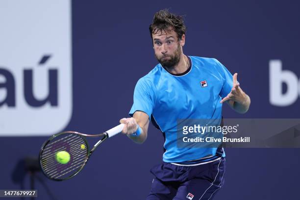 Quentin Halys of France plays a forehand against Daniil Medvedev in their fourth round match at Hard Rock Stadium on March 28, 2023 in Miami Gardens,...