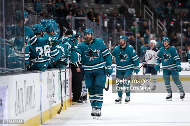 Martin Kaut of the San Jose Sharks is congratulated by teammates after he scored a goal against the Winnipeg Jets in the third period at SAP Center...