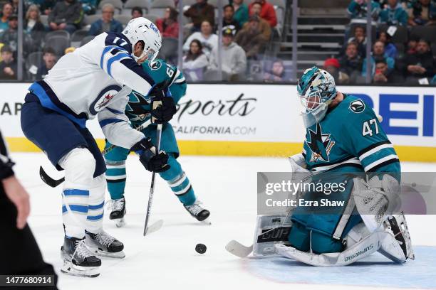 James Reimer of the San Jose Sharks makes a save on a shot taken by Adam Lowry of the Winnipeg Jets in the third period at SAP Center on March 28,...