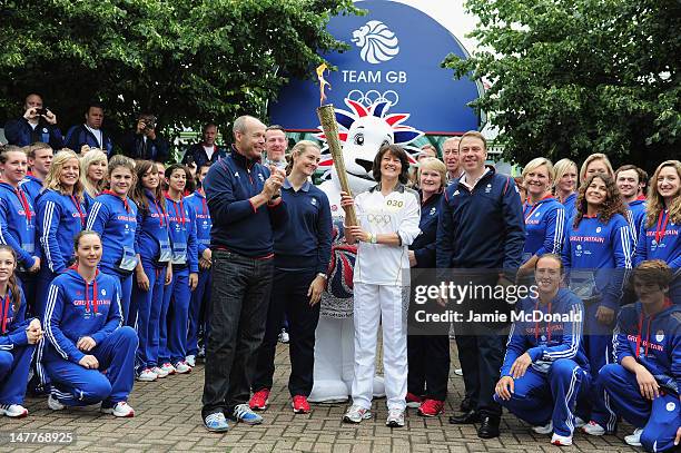 Audrey Cooper GB Coach of Woman's Volley Ball Team holds the torch with GB Chef de Mission Andy Hunt, Team GB Deputy Chef de Mission Sir Clive...