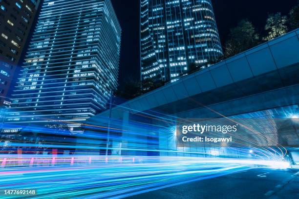 busy light trails passing through a tunnel in an urban city - isogawyi fotografías e imágenes de stock