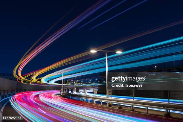 colorful light trails over a curved road against clear sky - electrical overload bildbanksfoton och bilder