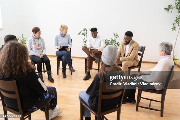 sitting in a circle the  mental health support group meeting - addiction recovery stock pictures, royalty-free photos & images