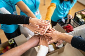 Volunteers hands stacking in a circle