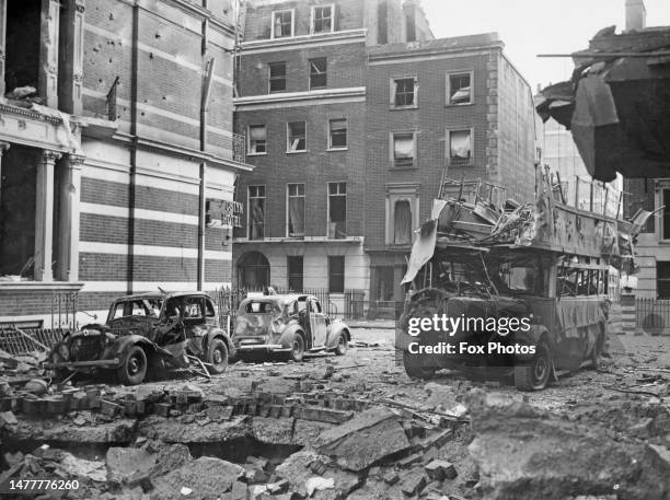 View of bomb damaged buildings, destroyed motor cars and a London Transport AEC Regent III RT double decker bus on Portman Street following an air...