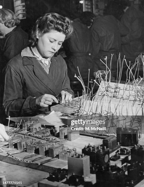 Female factory worker assembling electrical cable forms on 20th March 1941 at the East Ham Technical College assembly facility in London, England. .
