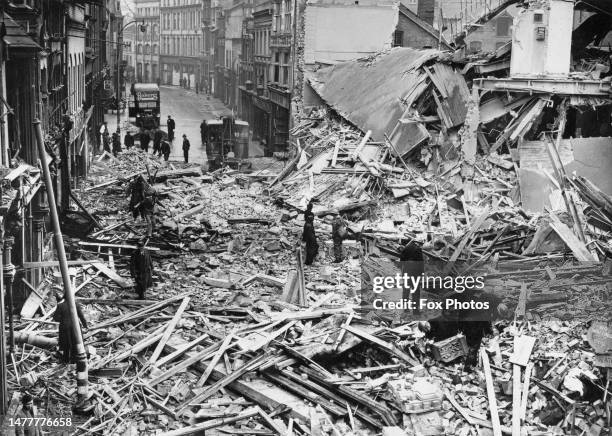 Civil Defence emergency services and Air Raid Precautions personnel search through the bomb damaged town centre of Reading after a Luftwaffe Dornier...