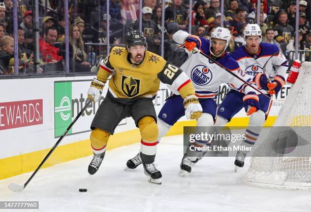 Chandler Stephenson of the Vegas Golden Knights skates with the puck ahead of Darnell Nurse and Nick Bjugstad of the Edmonton Oilers in the second...