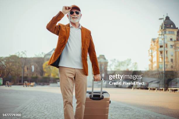 man carrying suitcase - baby boomer stock pictures, royalty-free photos & images