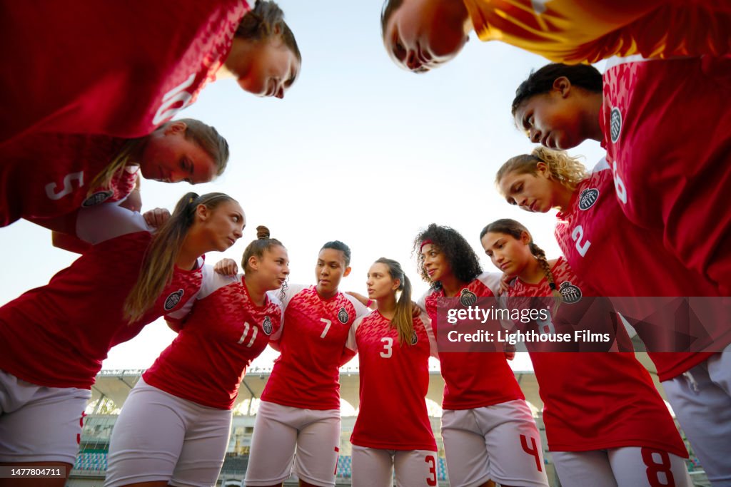 Low angled shot of a huddle with competitive women soccer players