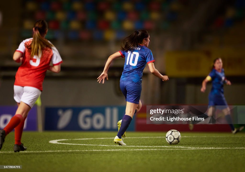 A skilled number 10 attacking midfielder controls the midfield during soccer game