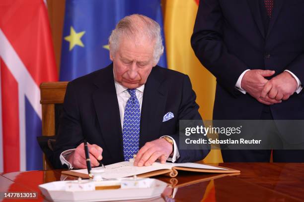 King Charles III signs the official guest book at Schloss Bellevue presidential palace on the first day of the state visit to Germany on March 29,...