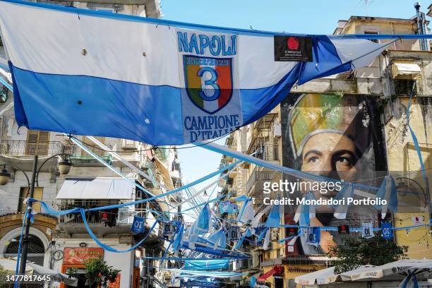 Banners, flags and a mural of San Gennaro by the artist Jorit, are seen in Forcella district as the city prepares for the probable victory of the...