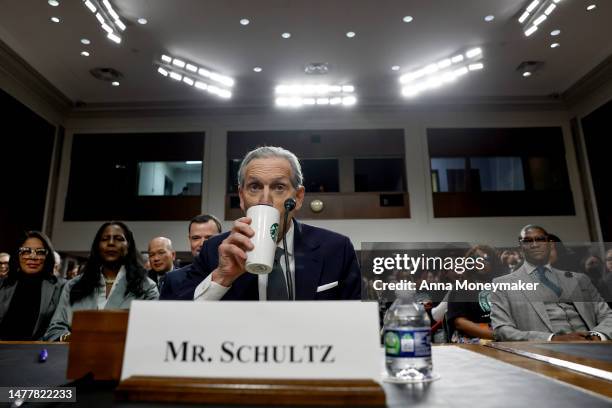Former Starbucks CEO Howard Schultz takes a drink from his Starbucks cup before testifying before the Senate Health, Education, Labor, and Pensions...