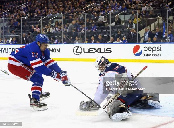 Filip Chytil of the New York Rangers is stopped by Michael Hutchinson of the Columbus Blue Jackets at Madison Square Garden on March 28, 2023 in New...