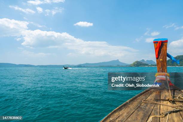 view of  railey beach in  krabi province from thai taxi boat - longtail boat stock pictures, royalty-free photos & images