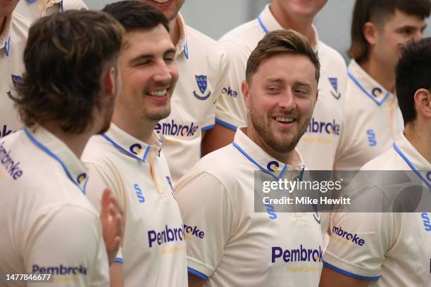 Ollie Robinson of Sussex shares a joke with team mate Steven Finn during a Sussex CCC Photocall at The 1st Central County Ground on March 29, 2023 in...