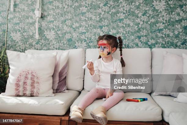 little girl drawing with crayon on face - girl sitting on boys face fotografías e imágenes de stock