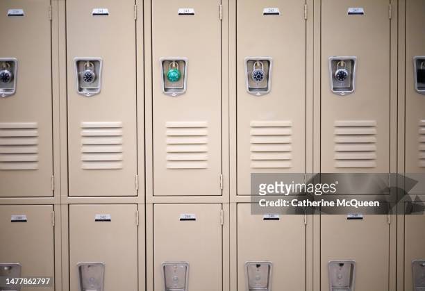 row of traditional metal school lockers - school lockdown stock pictures, royalty-free photos & images