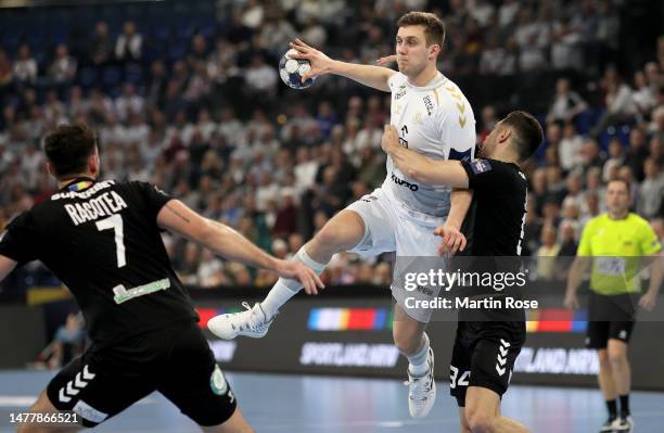 Mykola Bilyk of THW Kiel challenges Robert Miltaru of CS Dinamo Bucuresti during the EHF Champions League match between THW Kiel and CS Dinamo...