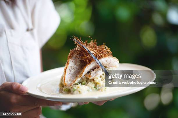 waitress serving fish fillet - seafood salad stock pictures, royalty-free photos & images