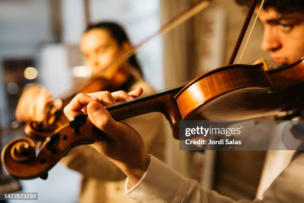 musicians playing a violin - orchestra rehearsal stock pictures, royalty-free photos & images