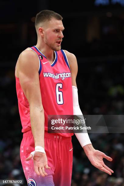 Kristaps Porzingis of the Washington Wizards gestures against the Boston Celtics during the second half at Capital One Arena on March 28, 2023 in...