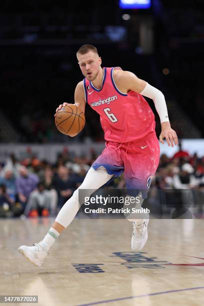 Kristaps Porzingis of the Washington Wizards dribbles against the Boston Celtics during the second half at Capital One Arena on March 28, 2023 in...