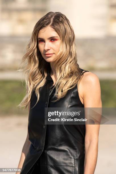 Xenia Adonts wears all Loewe with orange eyeliner outside the Loewe show on March 03, 2023 in Paris, France.