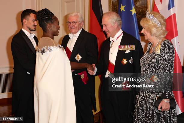German President Frank-Walter Steinmeier, King Charles III and Camilla, Queen Consort greet Evgenij Voznyuk and Motsi Mabuse on March 29, 2023 in...