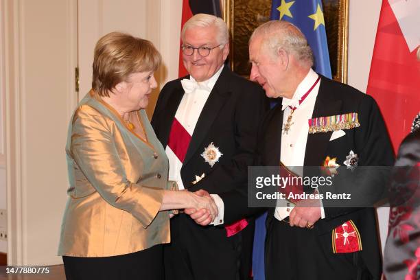 German President Frank-Walter Steinmeier and King Charles III greet Former German Chancellor Angela Merkel during a state banquet defilee at Schloss...