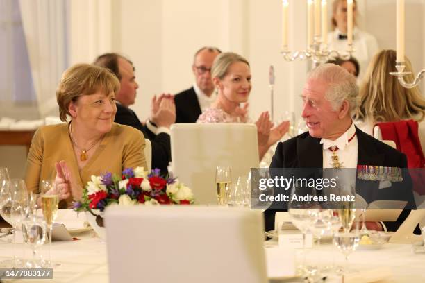 Former German Chancellor Angela Merkel and King Charles III attend a state banquet at Schloss Bellevue presidential palace on March 29, 2023 in...