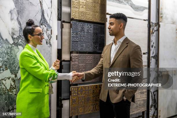 handshake after successful shopping in a ceramic tiles shop - storefront-for-art-and-architecture stock pictures, royalty-free photos & images