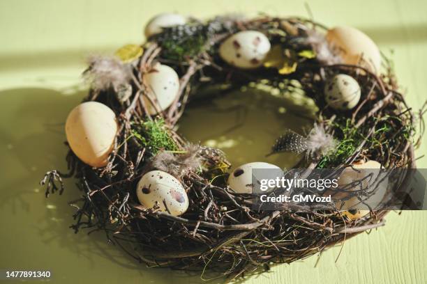 easter decoration with easter wreath and eggs - easter wreath stock pictures, royalty-free photos & images