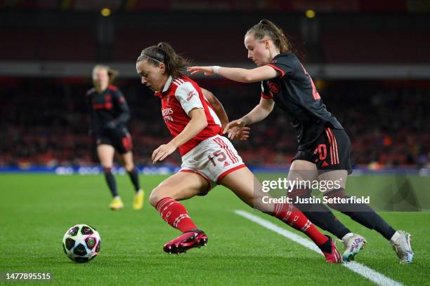 Katie McCabe of Arsenal runs with the ball whilst under pressure from Franziska Kett of FC Bayern Munich during the UEFA Women's Champions League...