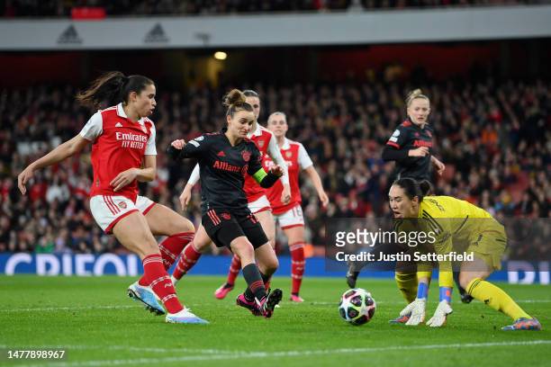 Manuela Zinsberger of Arsenal collects the ball whilst under pressure from Lina Magull of FC Bayern Munich during the UEFA Women's Champions League...