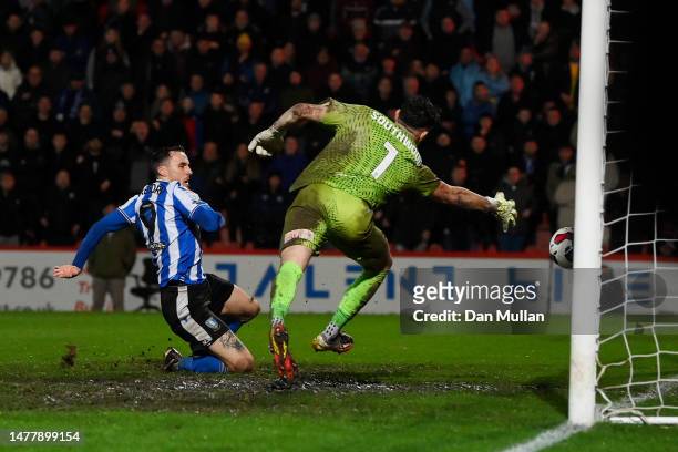 Lee Gregory of Sheffield Wednesday scores the team's second goal past Luke Southwood of Cheltenham Town during the Sky Bet League One between...