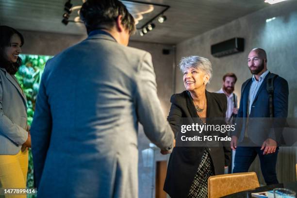 business people greeting at the office - dignity elderly stock pictures, royalty-free photos & images