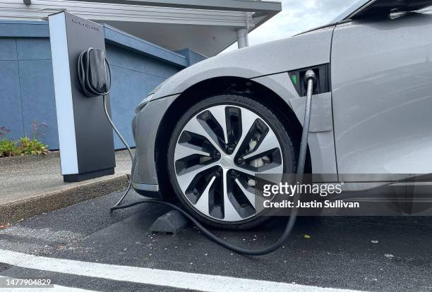 Lucid electric vehicle sits parked at a charging station outside of a Lucid Studio on March 29, 2023 in Corte Madera, California. Electric vehicle...