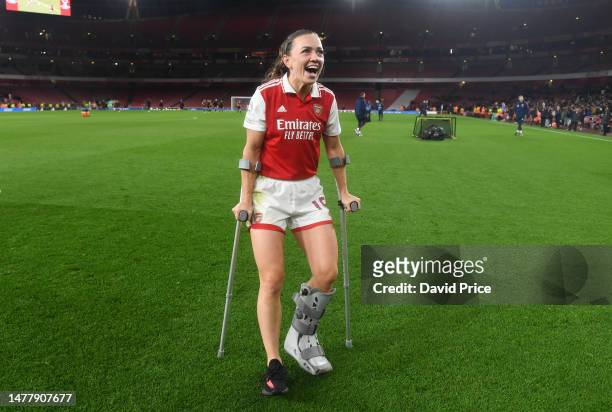 Katie McCabe of Arsenal is seen with crutches after picking up an injury in the game as they celebrate victory in the UEFA Women's Champions League...