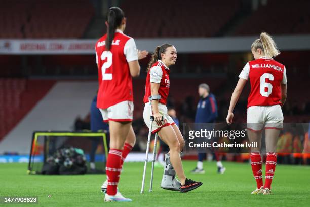 Katie McCabe of Arsenal, seen with crutches after picking up an injury in the game, speaks with teammate Leah Williamson following the UEFA Women's...